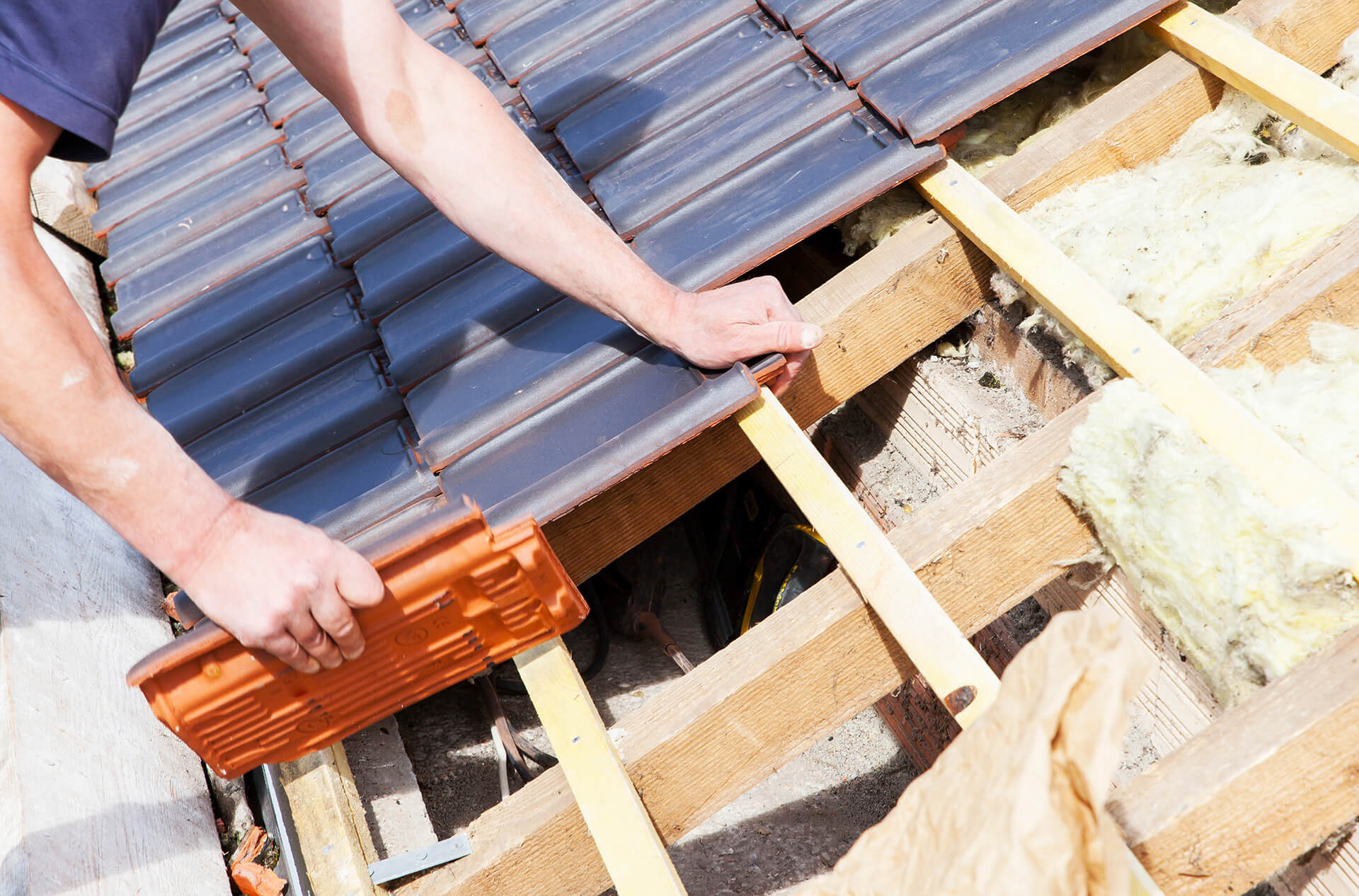 a male worker fixing a roof